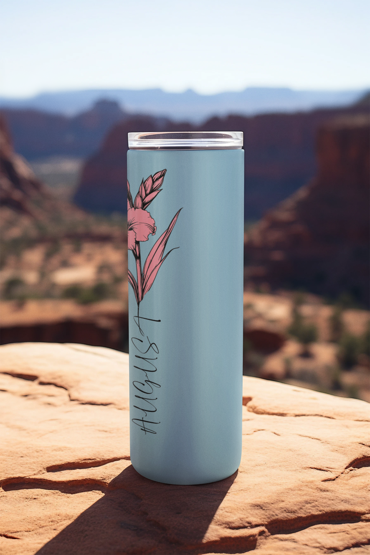 Closeup of mint background and August flower script on tumbler