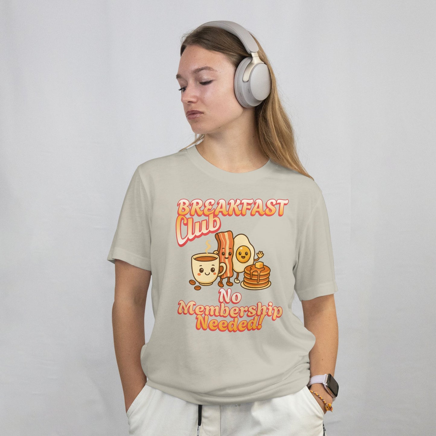 Person wearing a t-shirt with 'Breakfast Club No Membership Needed' design on a plain background