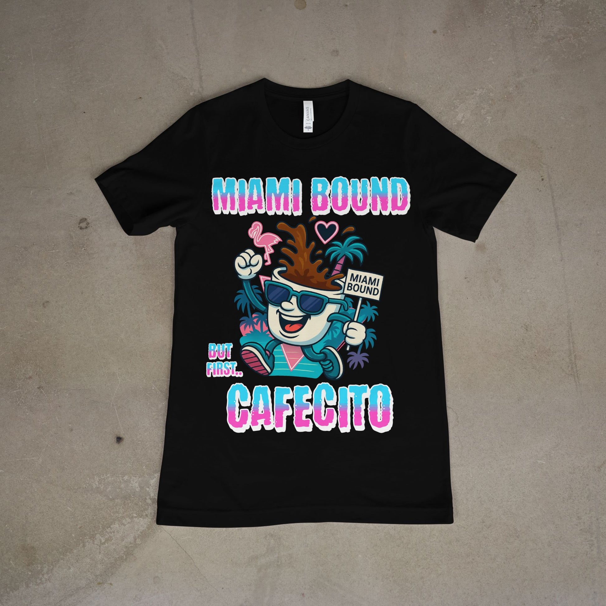 Black t-shirt with colorful graphic and text on a beige surface