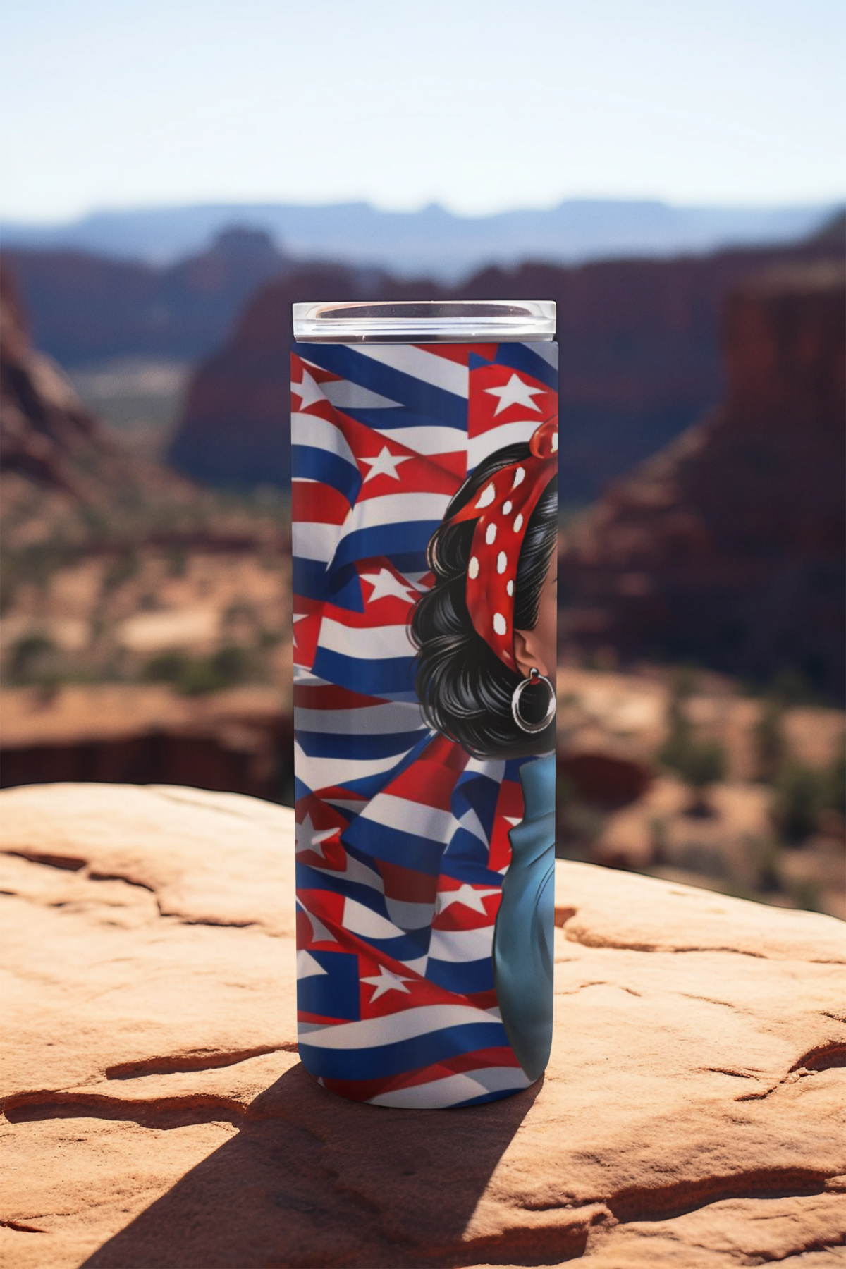 Custom Cuban-inspired 20oz stainless steel tumbler featuring “Maria La Valiente” design with a strong Latina character in a red bandana, placed on a scenic outdoor background. Side view