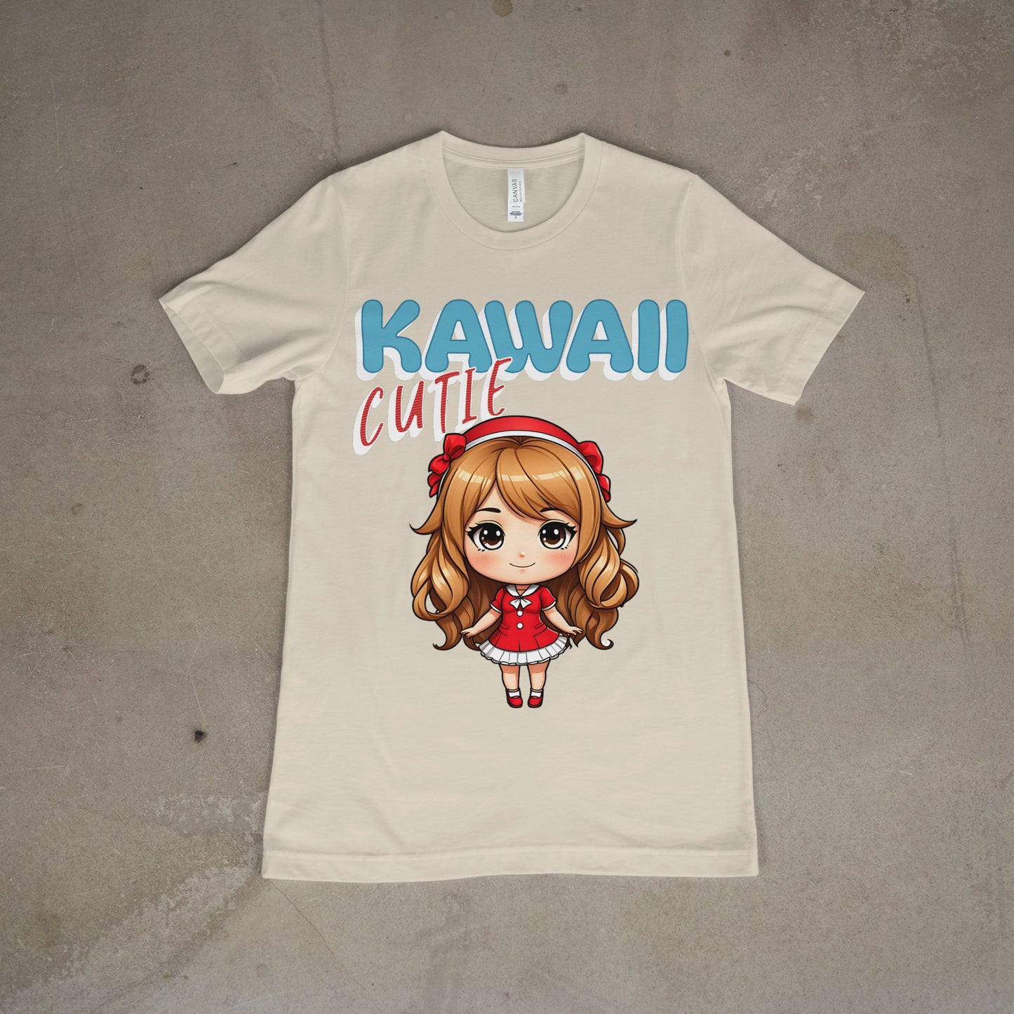 heathered oatmeal, women's graphic t-shirt featuring bold pastel text that says "Kawaii Cutie" in blue, pink, and white, laid flat on a concrete background.