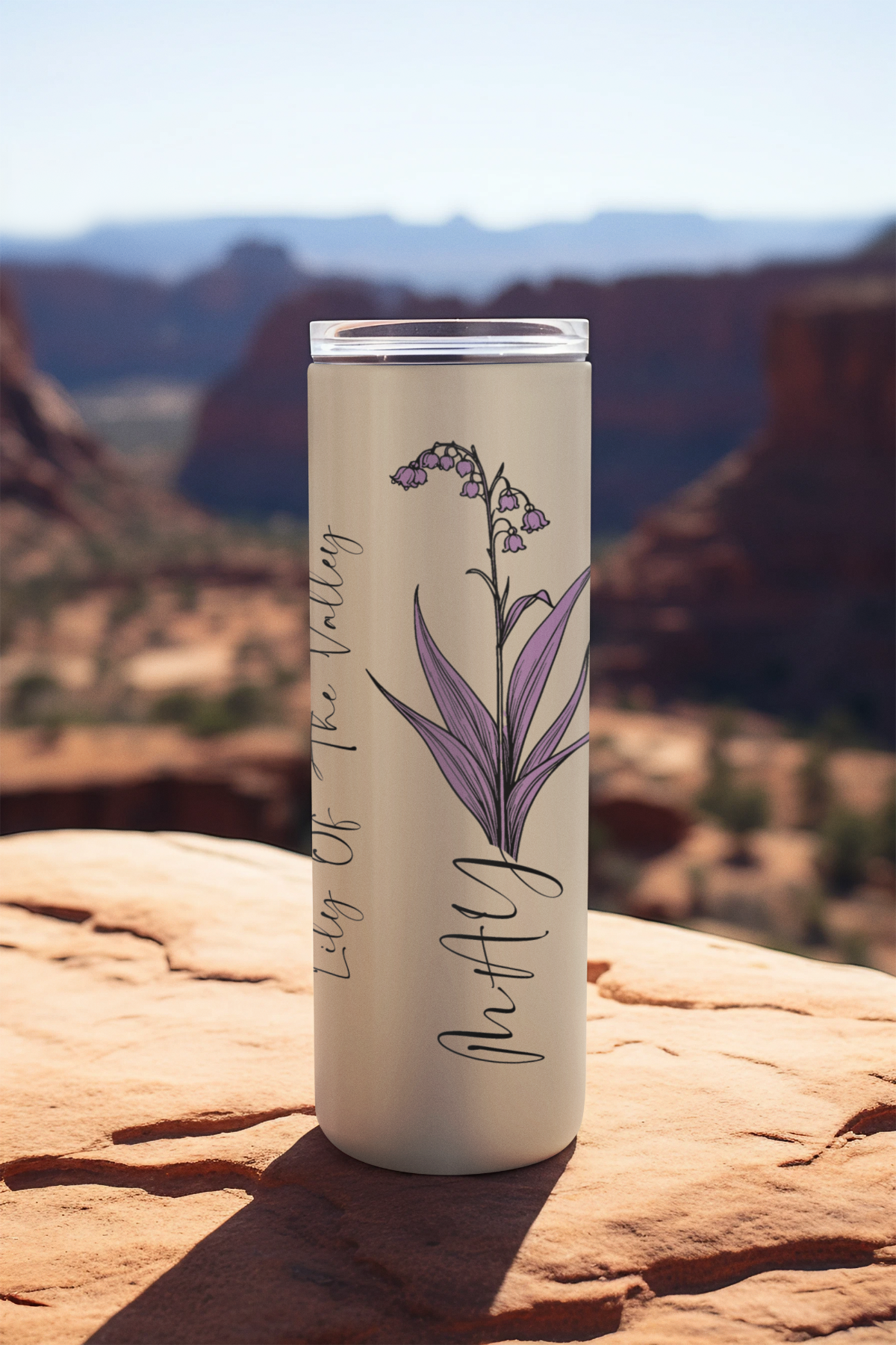 20oz May tumbler featuring lily of the valley flower design on soft beige background