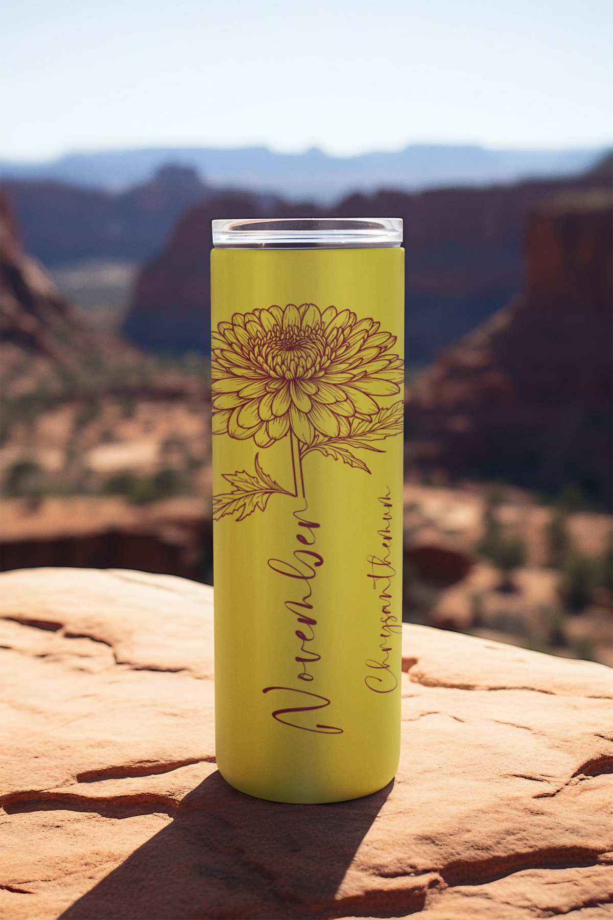 Front view of custom November tumbler with lemon yellow floral design on stainless steel background