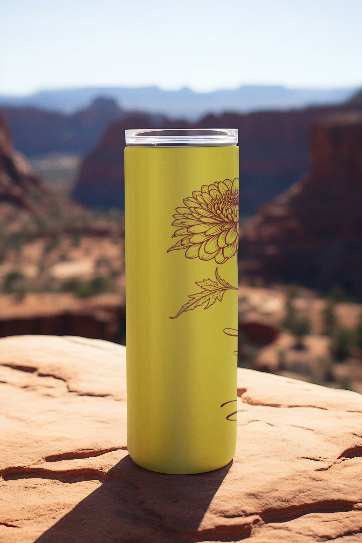 20oz lemon yellow floral tumbler standing on scenic rock ledge with mountain view