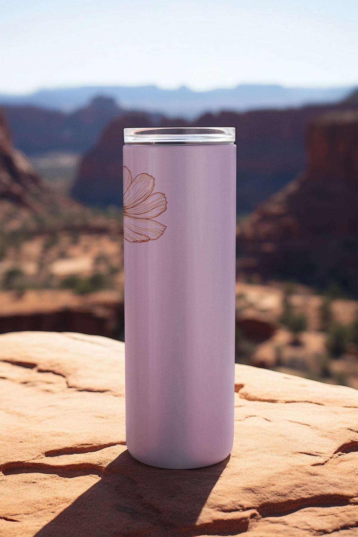 Side profile of skinny 20oz stainless tumbler with autumn-inspired flower line art