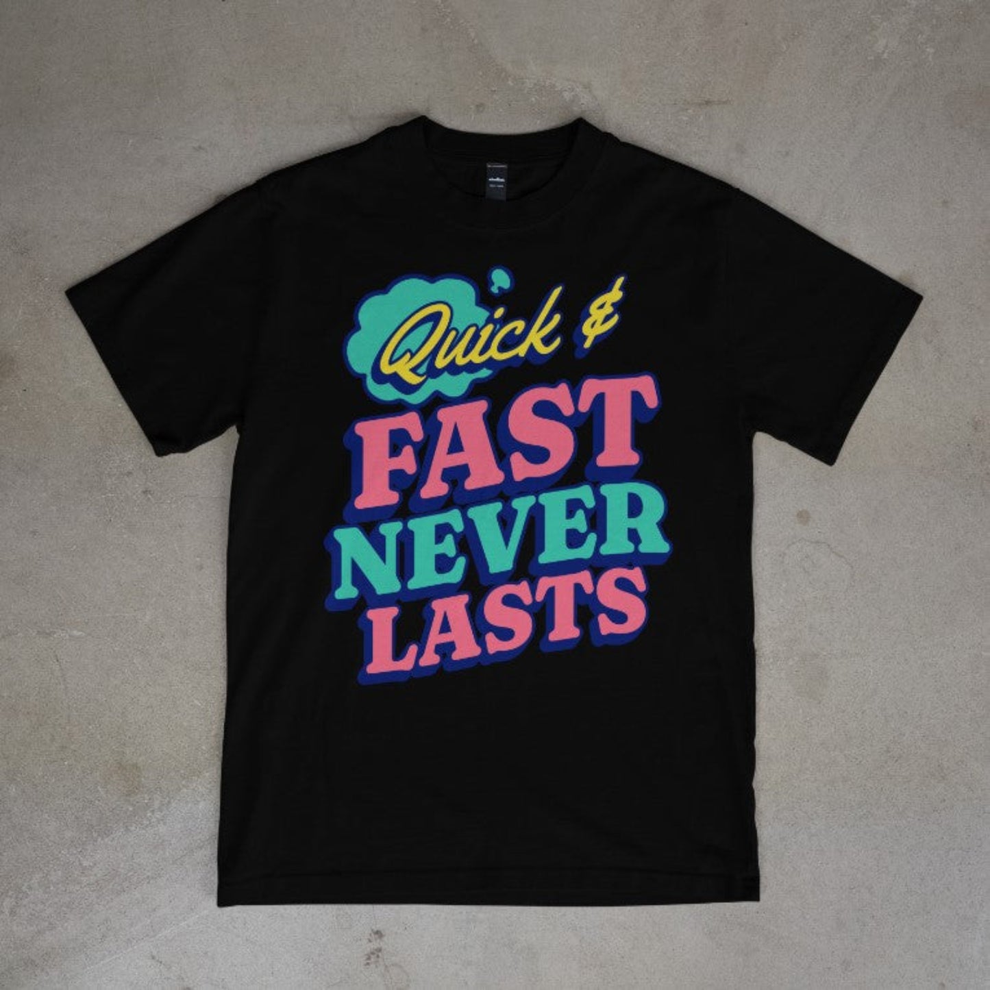 Black tee with vibrant pink, blue, and green typography design