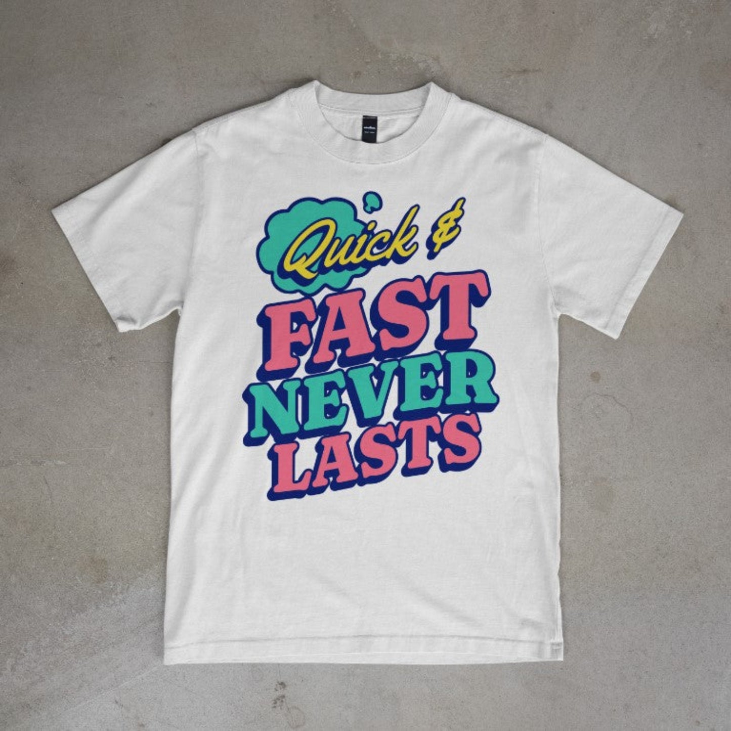 White tee with colorful typography that reads “Quick & Fast Never Lasts”