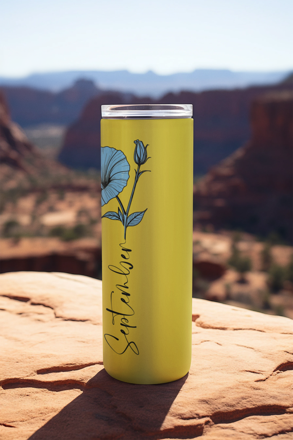 Side angle of stainless steel tumbler with blue flower line art and cursive text