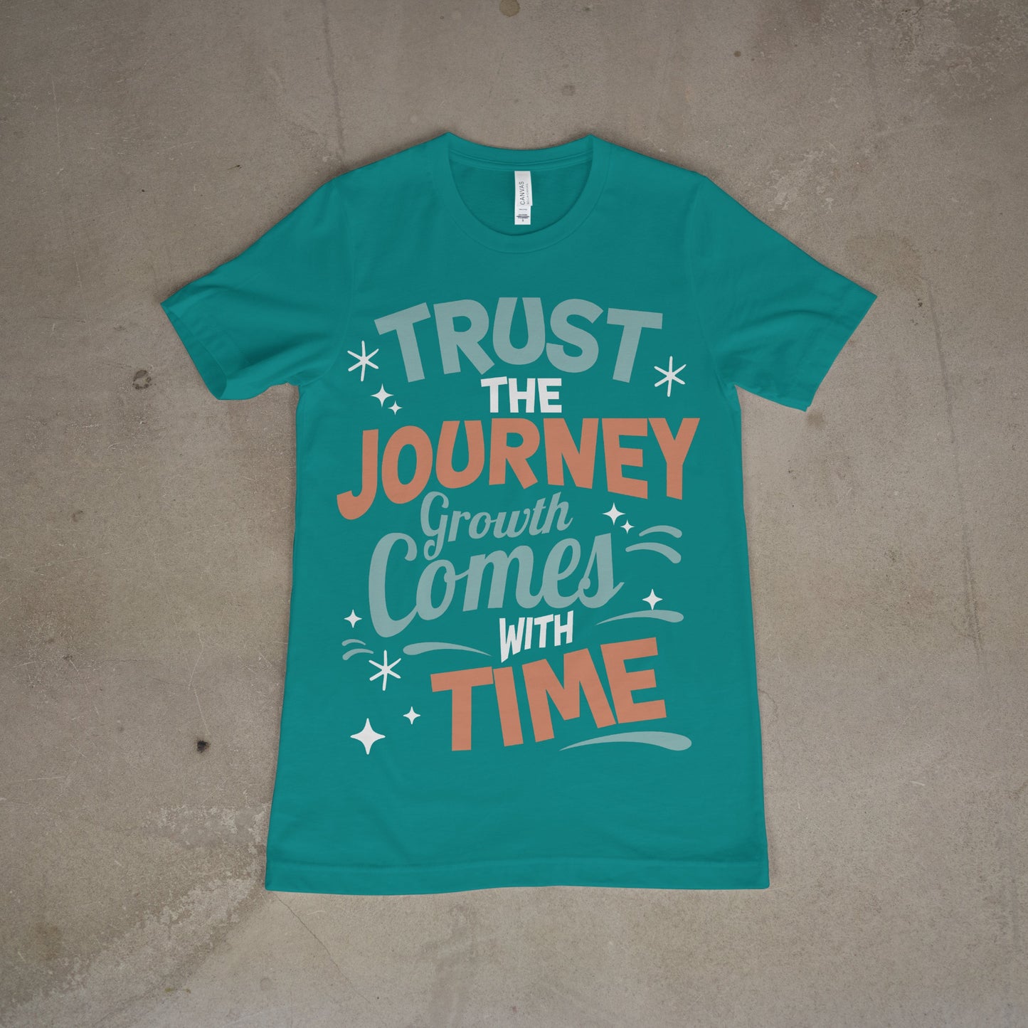 Teal shirt with bold motivational quote in white and coral text