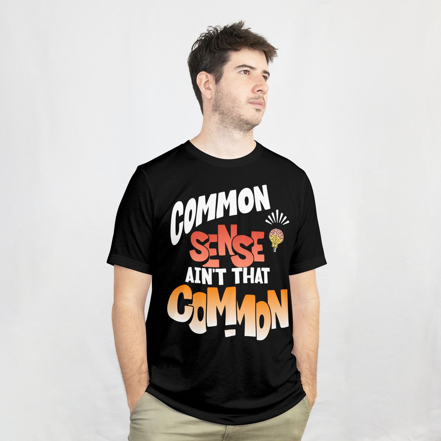 Person wearing a black t-shirt with colorful text design on a white background