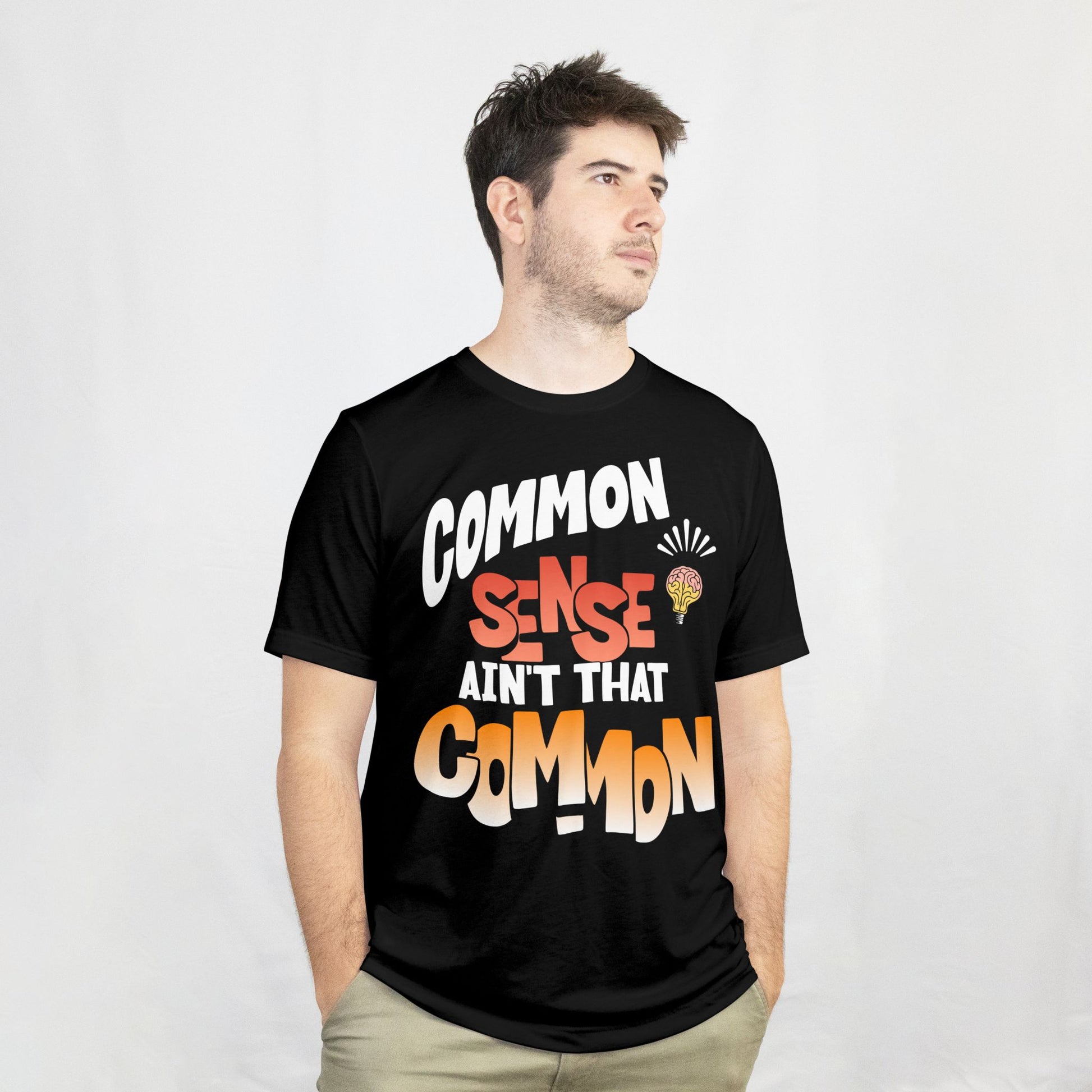 Person wearing a black t-shirt with colorful text design on a white background