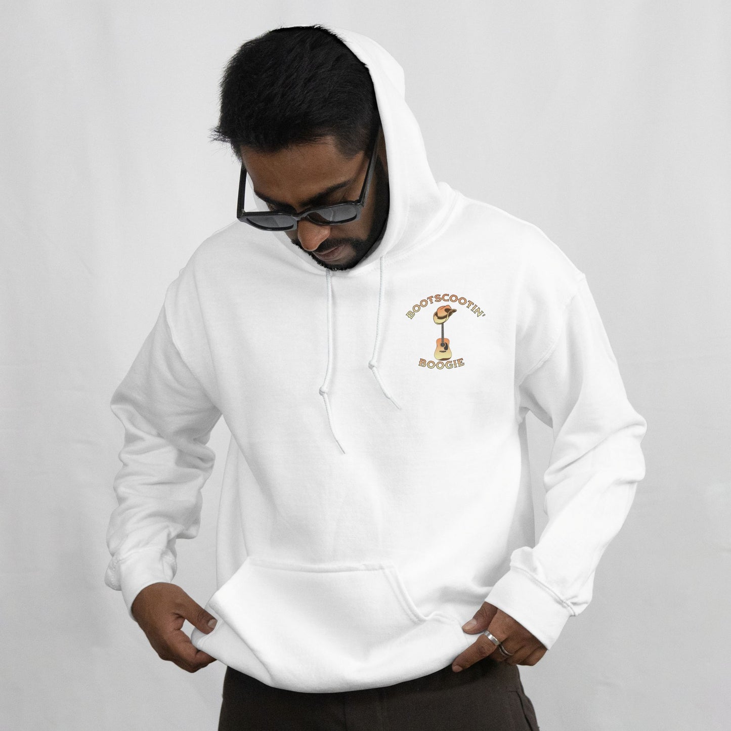 Person wearing a white hoodie with a logo on a gray background