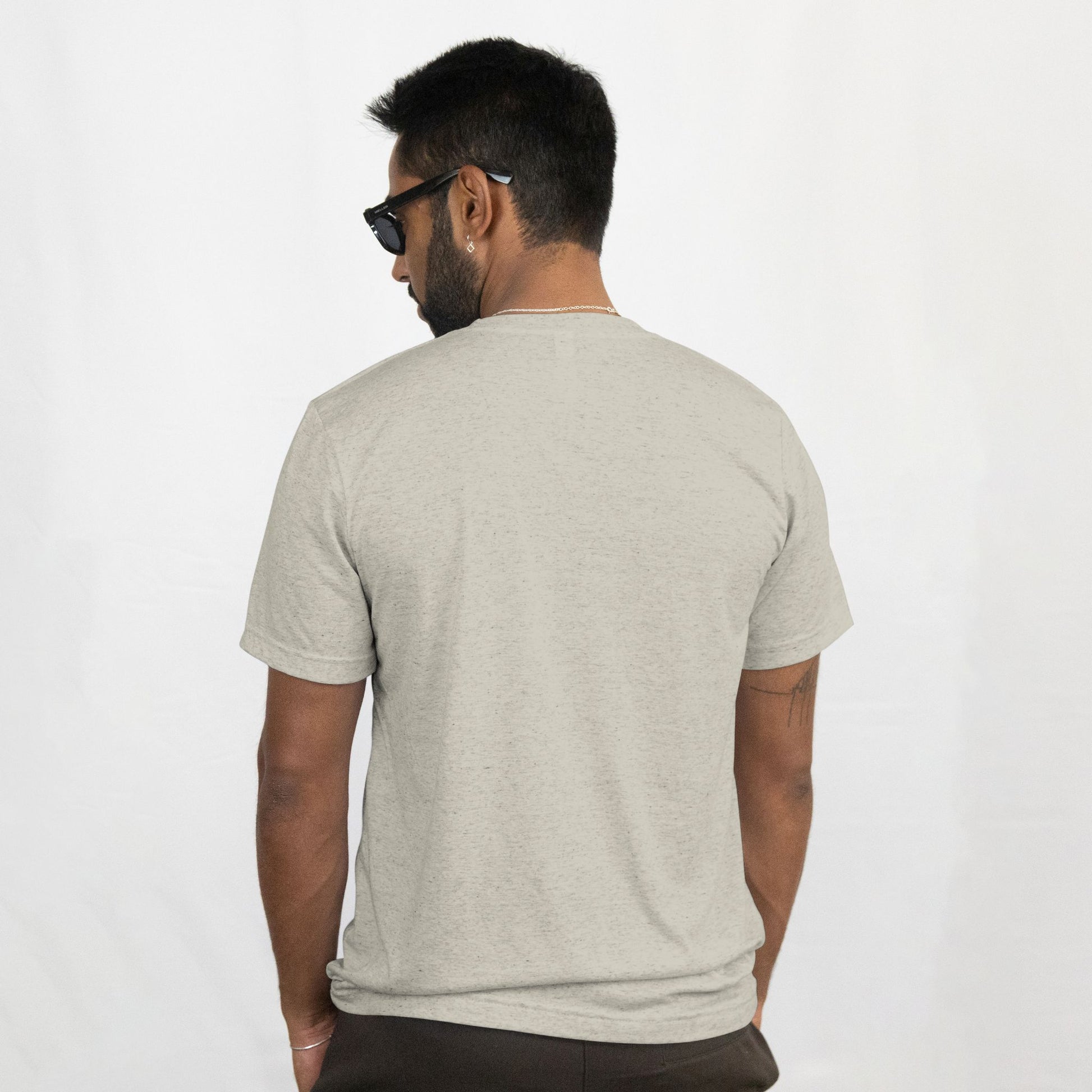 Man wearing a light gray t-shirt on a white background