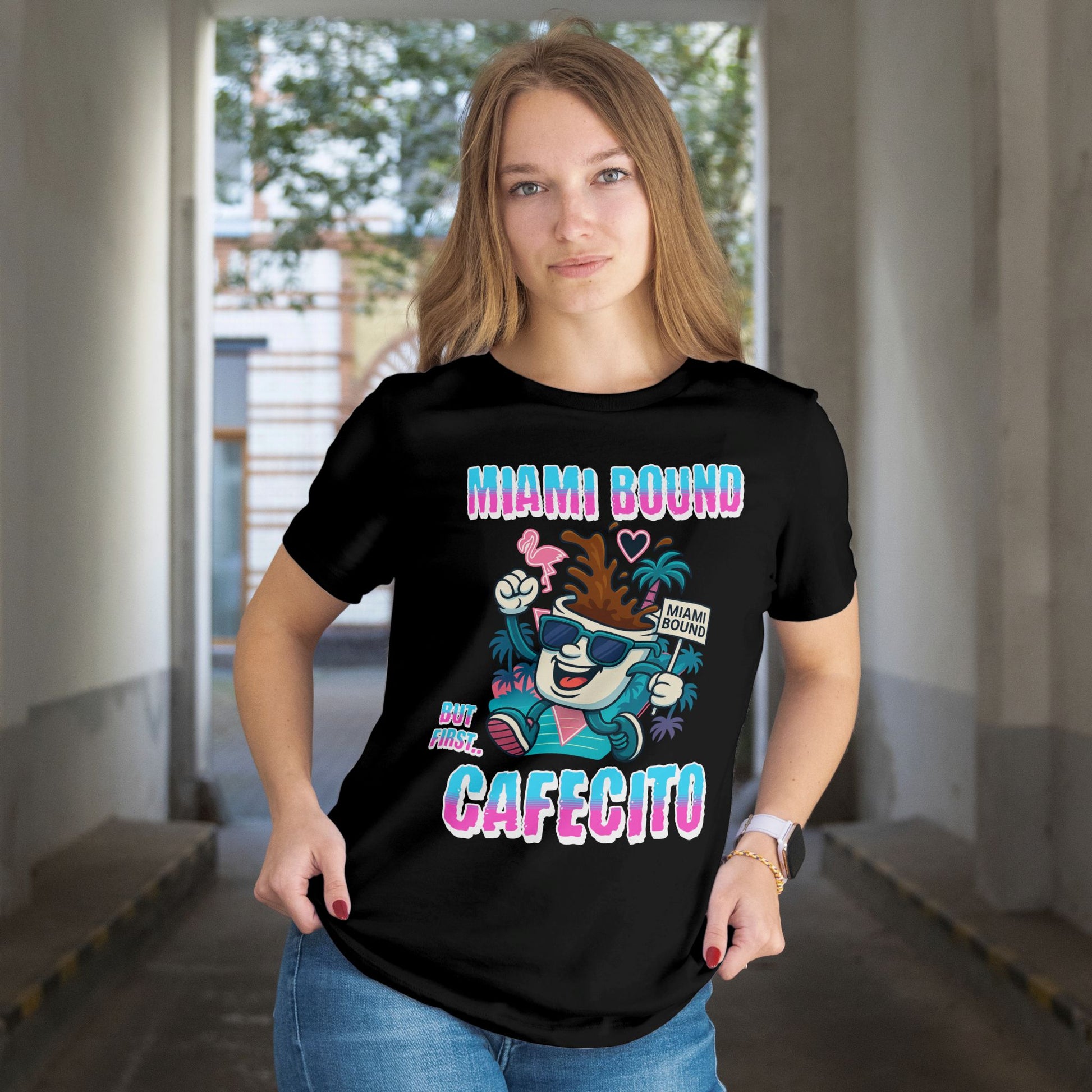 Person wearing a black t-shirt with colorful graphics and text in an indoor setting