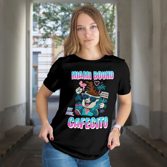 Person wearing a black t-shirt with colorful graphics and text in an indoor setting