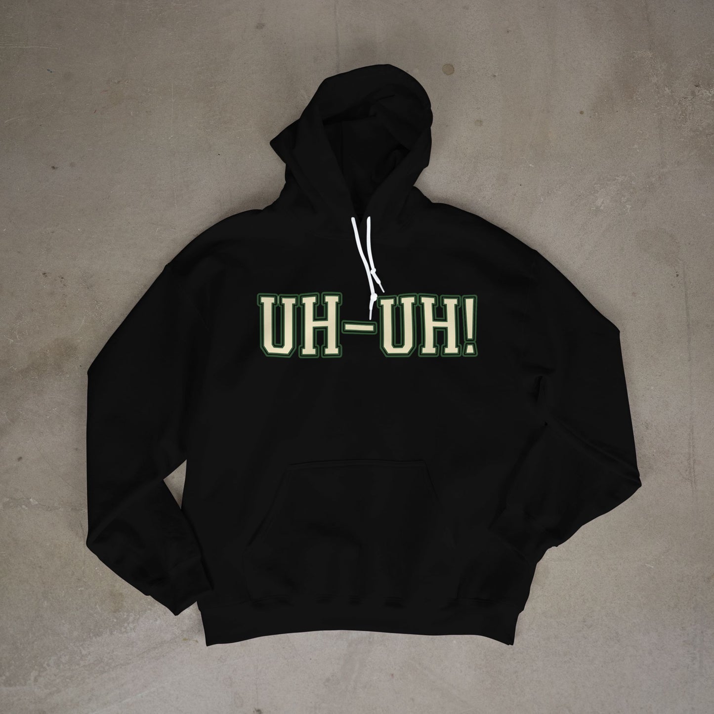 Black hoodie with 'UH-UH!' text on a concrete floor