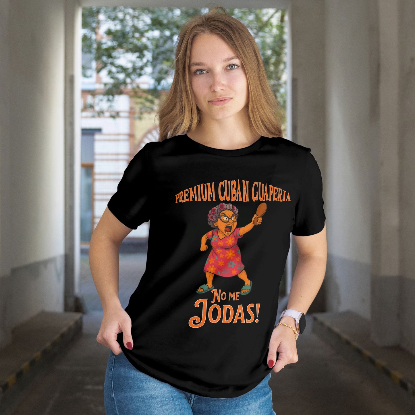 Person wearing a black t-shirt with a graphic design and text in an indoor setting. Text on shirt reads Premium Cuban Guaperia