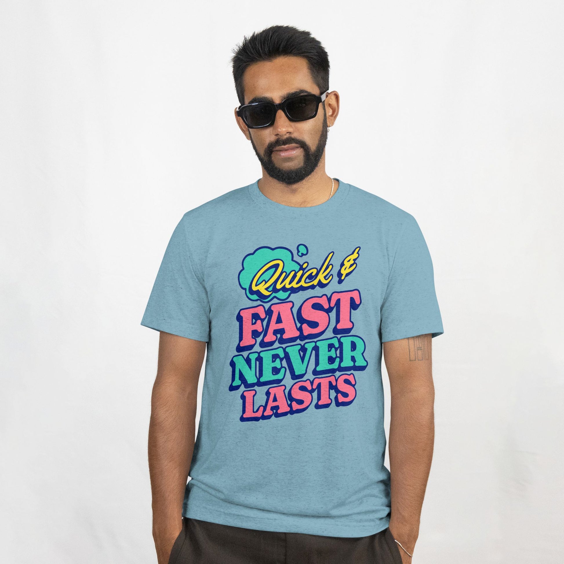 Man wearing a light blue t-shirt with colorful text on a white background