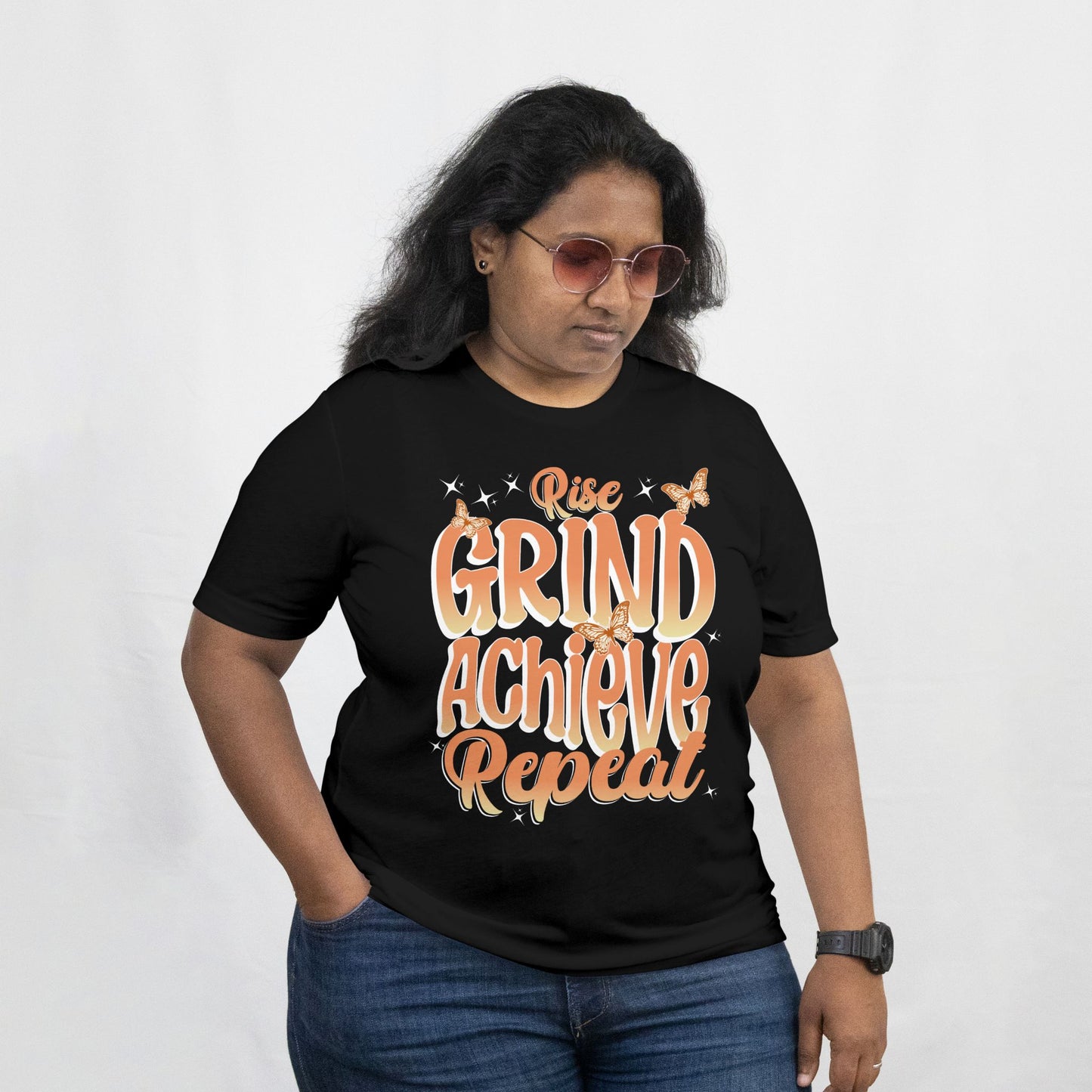 Person wearing a black t-shirt with motivational text on a white background