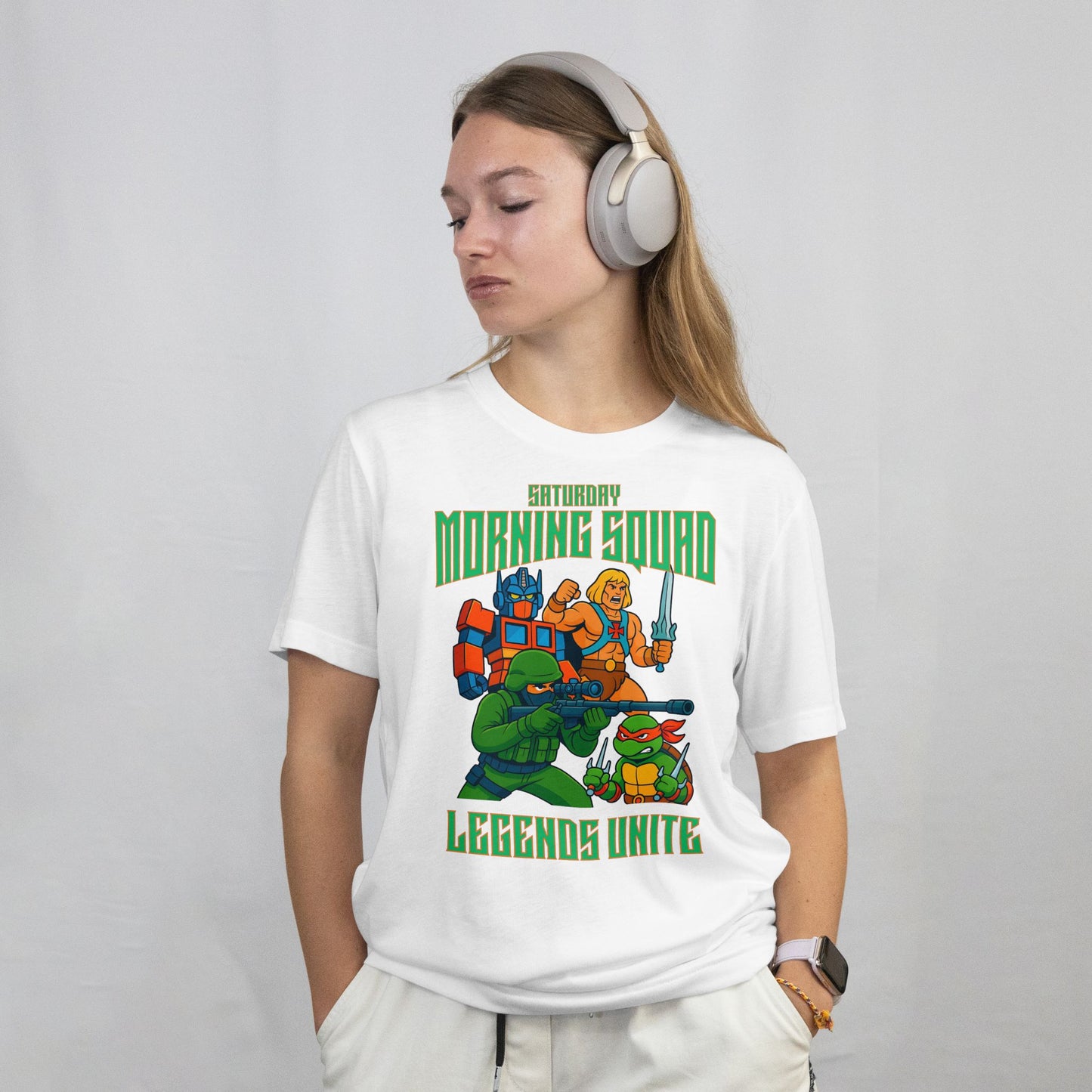 Person wearing a white t-shirt with 'Saturday Morning Squad' graphic design on a plain background