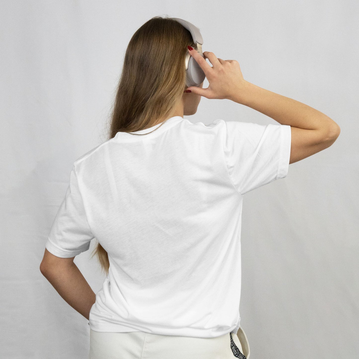 Person wearing a white t-shirt against a plain background