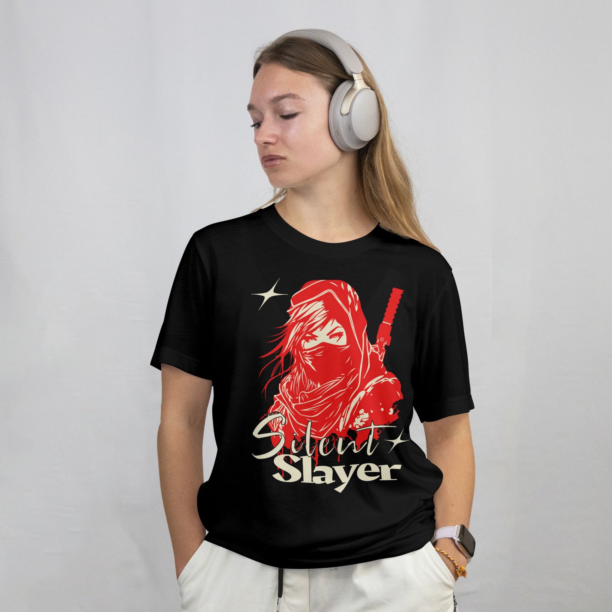 Person wearing a black t-shirt with a red graphic and 'Silent Slayer' text, headphones on, on a plain background
