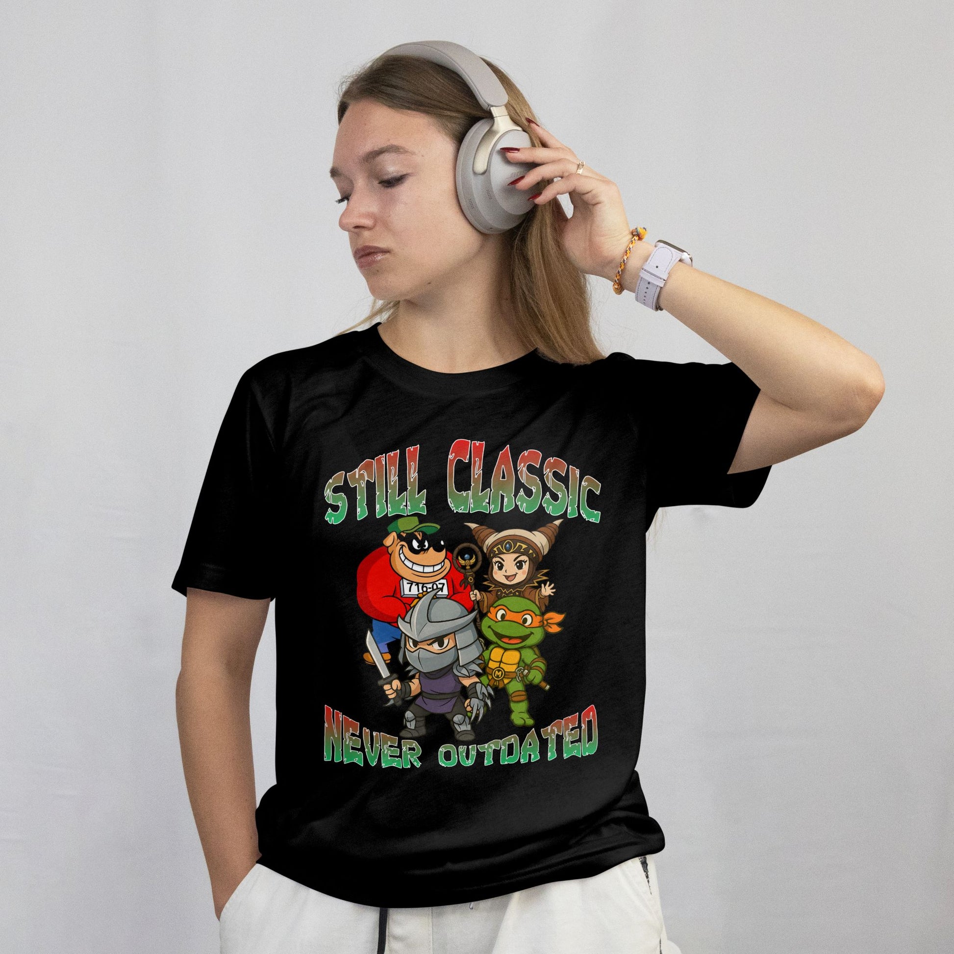 Person wearing a black t-shirt with cartoon characters and text on a plain background