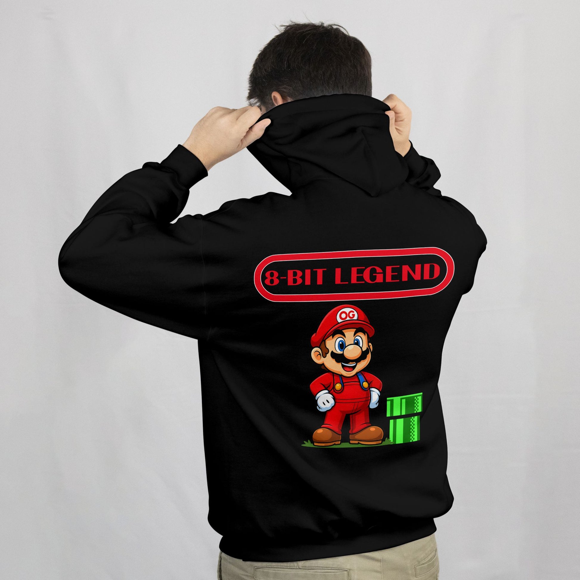 Black hoodie with '8-Bit Legend' design featuring a character and text on the back, worn by a person.