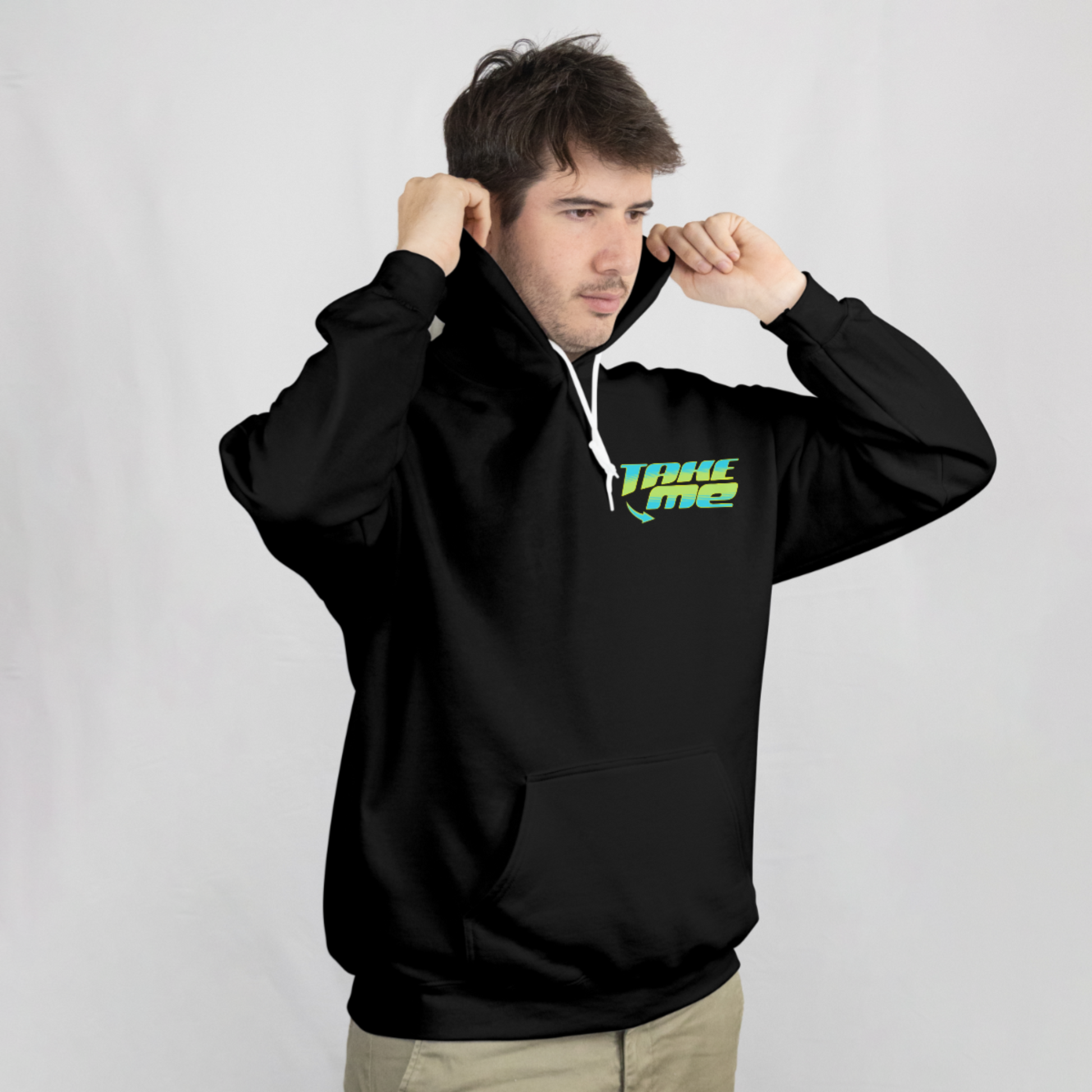 Man wearing black hoodie with small left-chest graphic that says “Take Me” in teal and yellow lettering