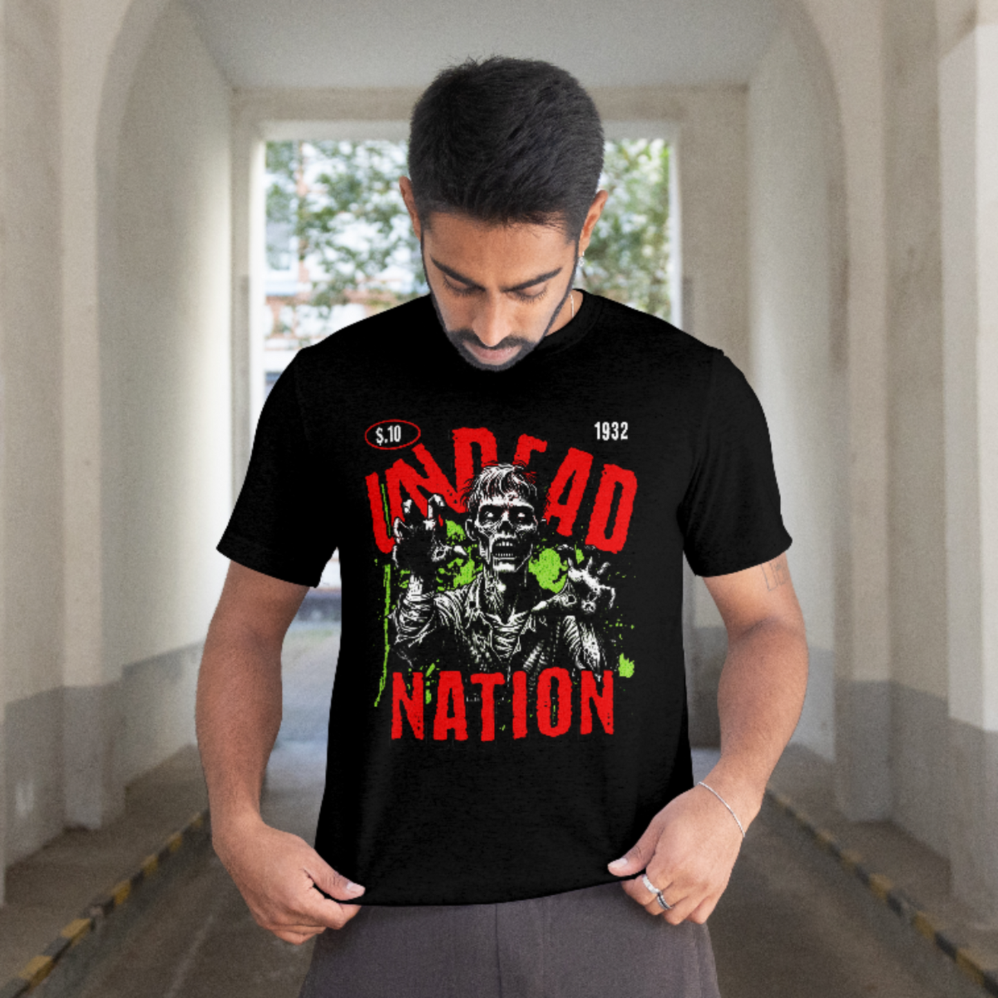 Man wearing black “Undead Nation” zombie graphic t-shirt with red and green horror design
