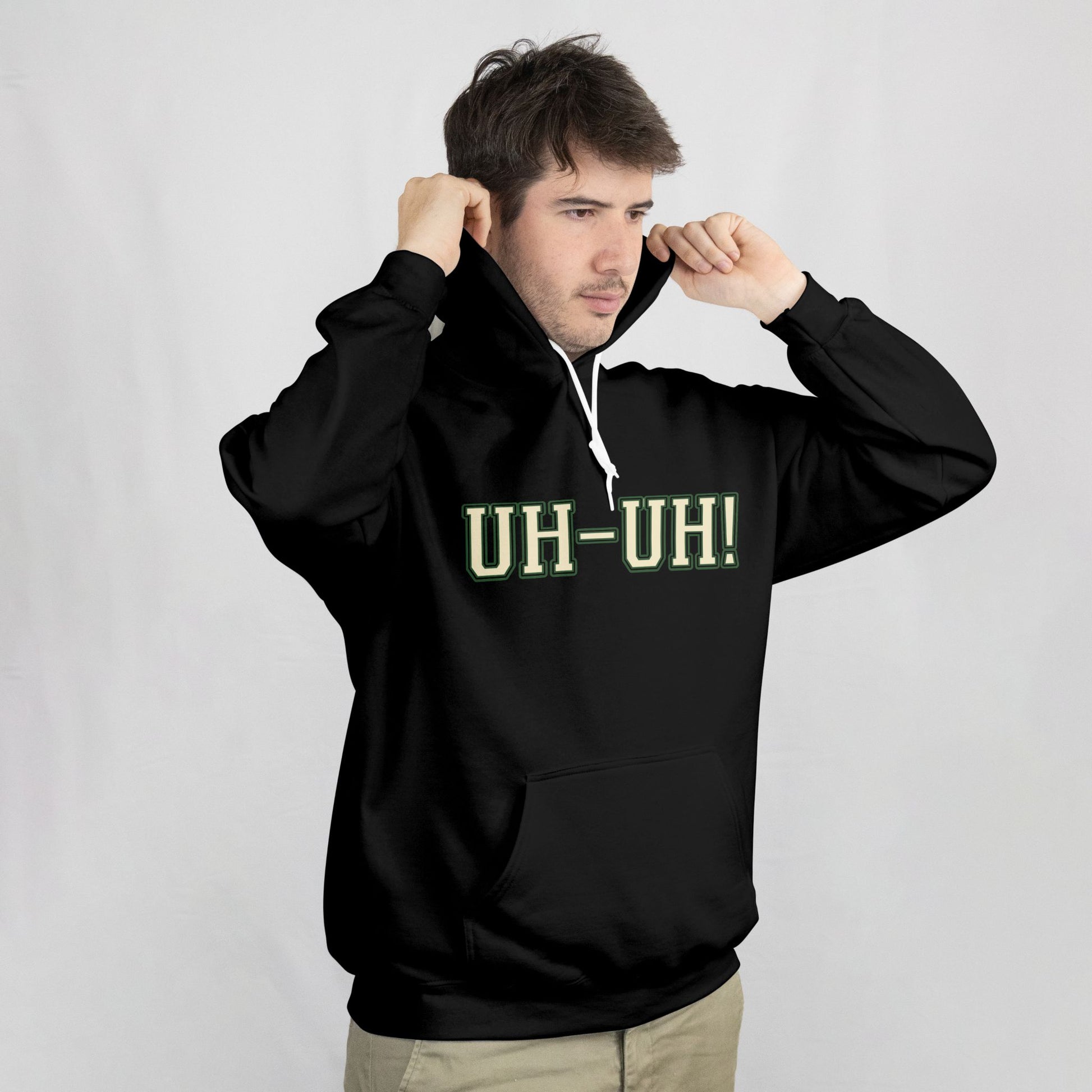 Person wearing a black hoodie with 'UH-UH!' text on a plain background