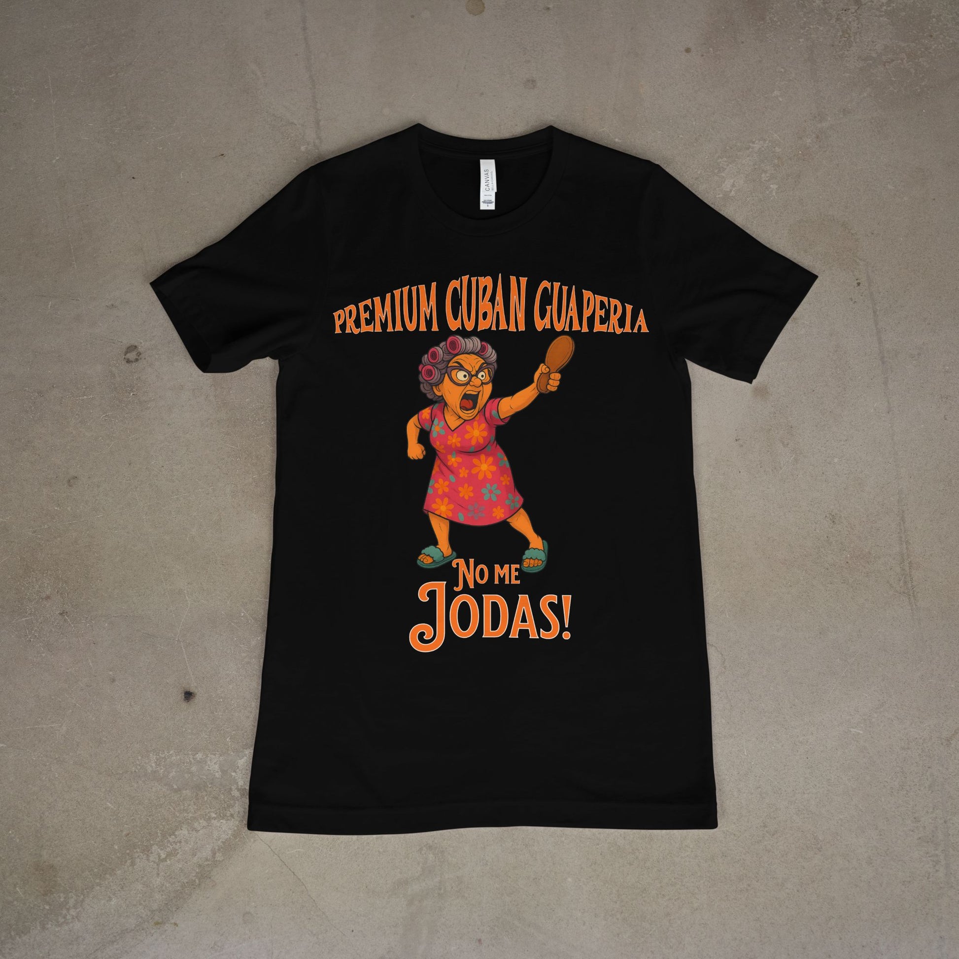Black t-shirt with colorful graphic and text on a concrete floor. Text reads Premium Cuban Guaperia