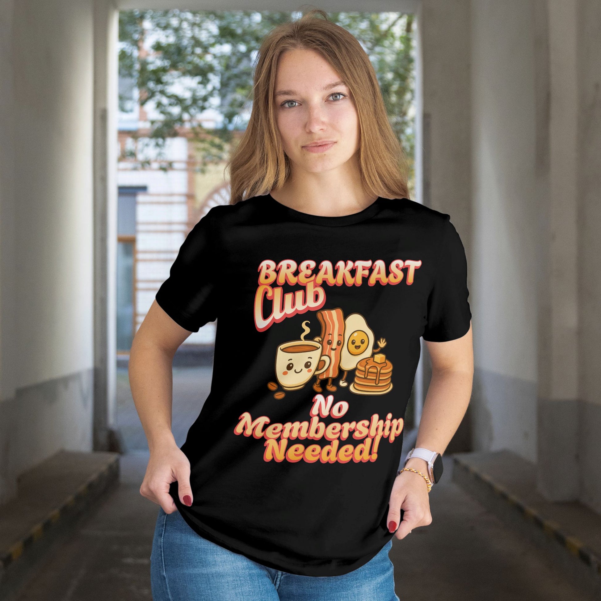 Person wearing a black t-shirt with 'Breakfast Club No Membership Needed!' text and graphics.