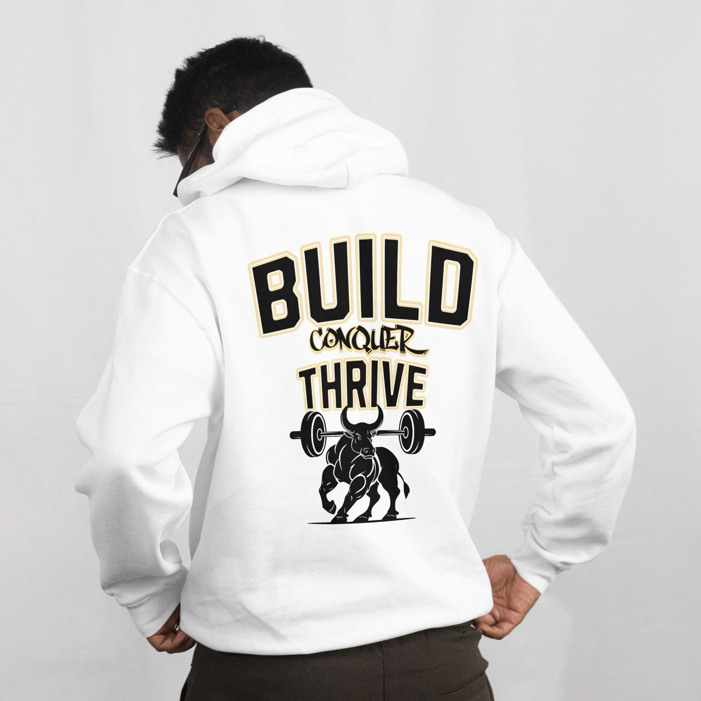Person wearing a white hoodie with motivational text and graphic on the back against a gray background