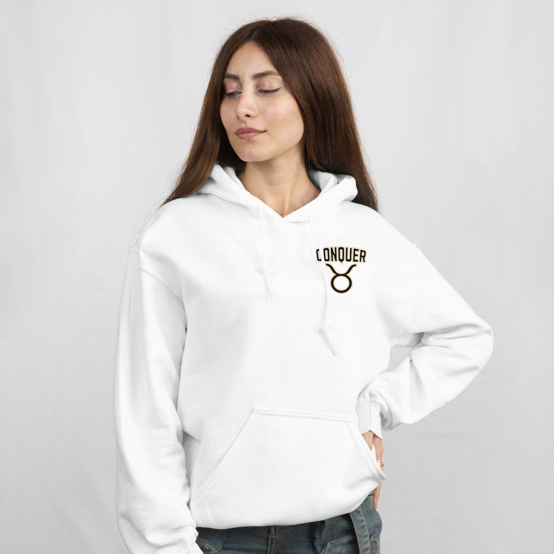 Woman wearing a white hoodie with 'Conquer' logo on a light gray background