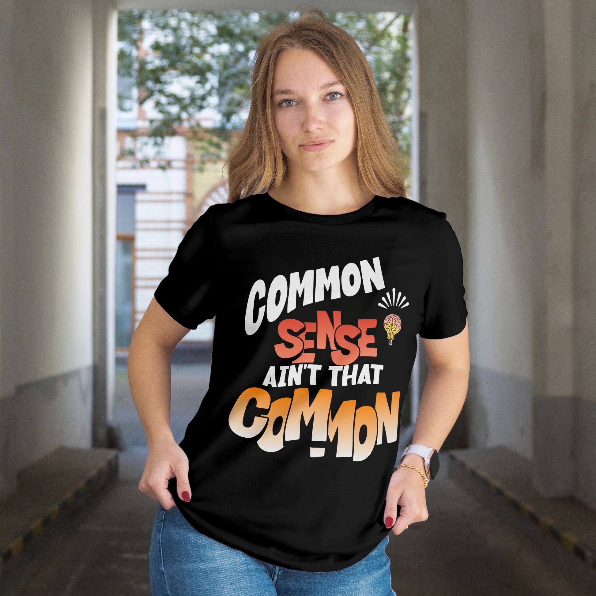 Person wearing a black t-shirt with colorful text in an indoor setting