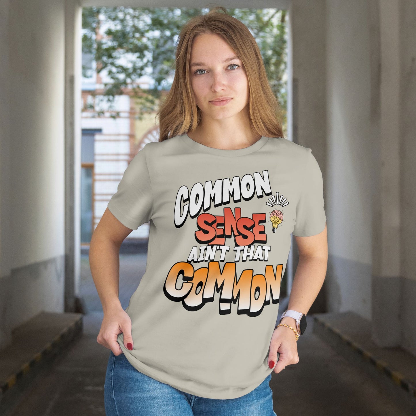 Person wearing a t-shirt with a humorous text design in an indoor setting.