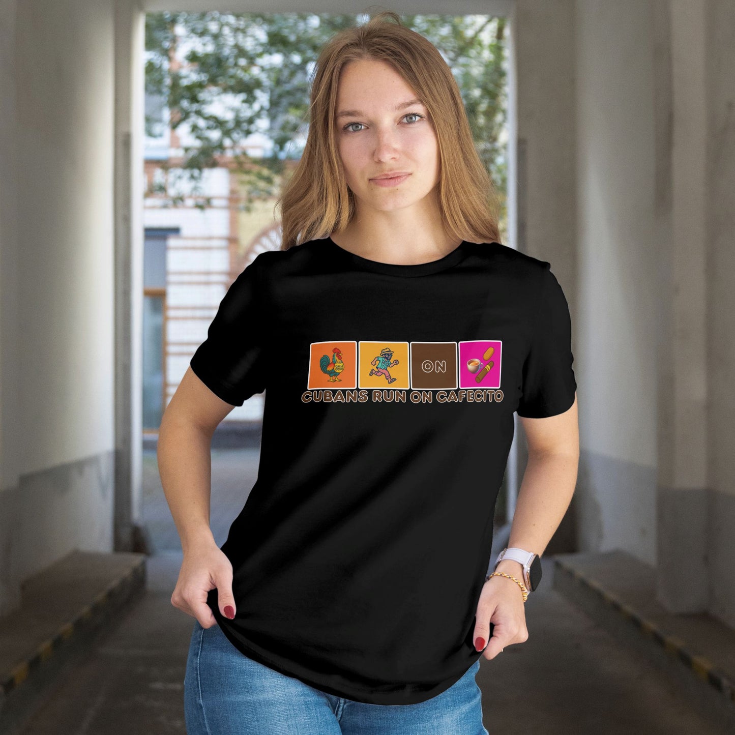 Person wearing a black t-shirt with colorful graphics and text in an indoor setting