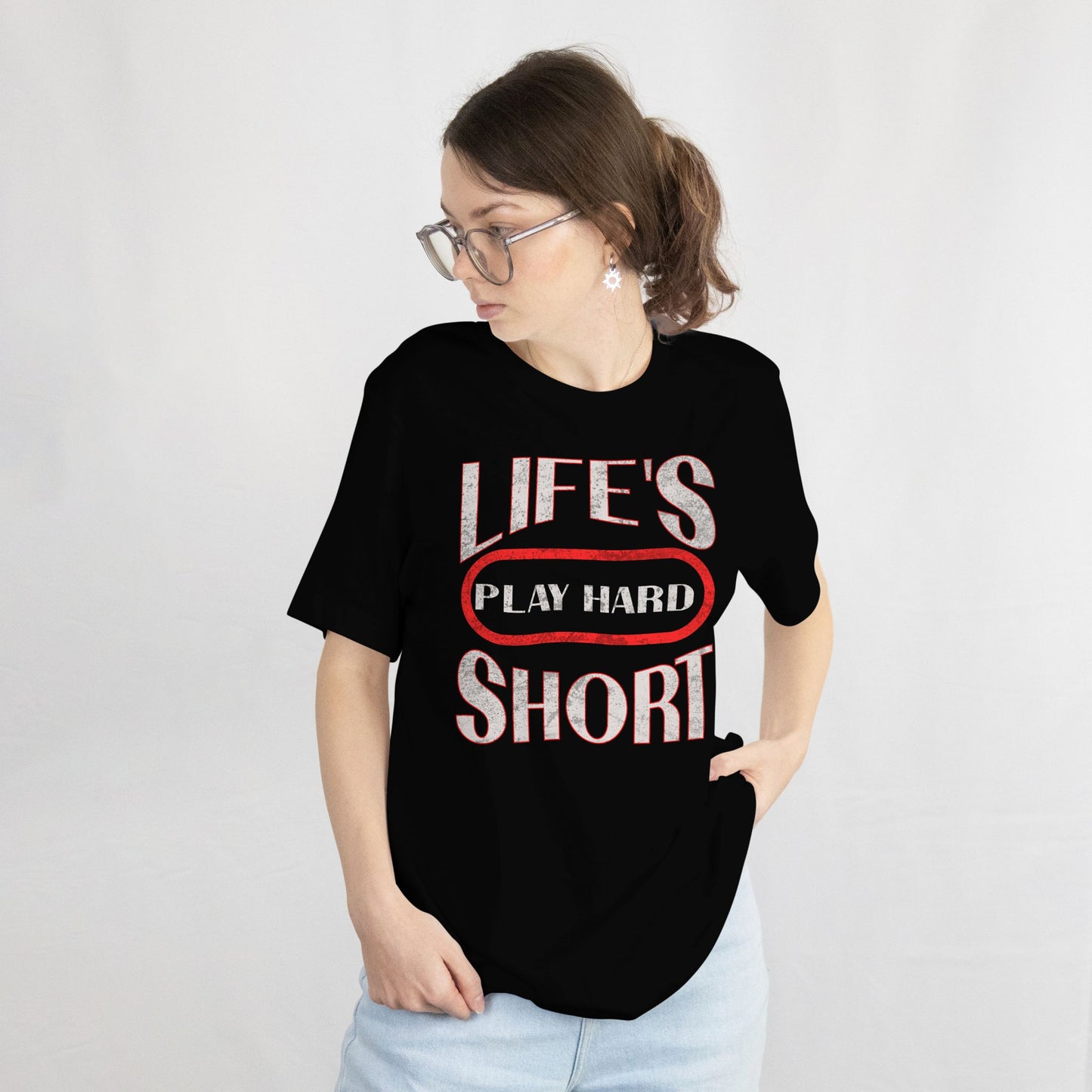 Person wearing a black t-shirt with 'LIFE'S PLAY HARD SHORT' text on a white background