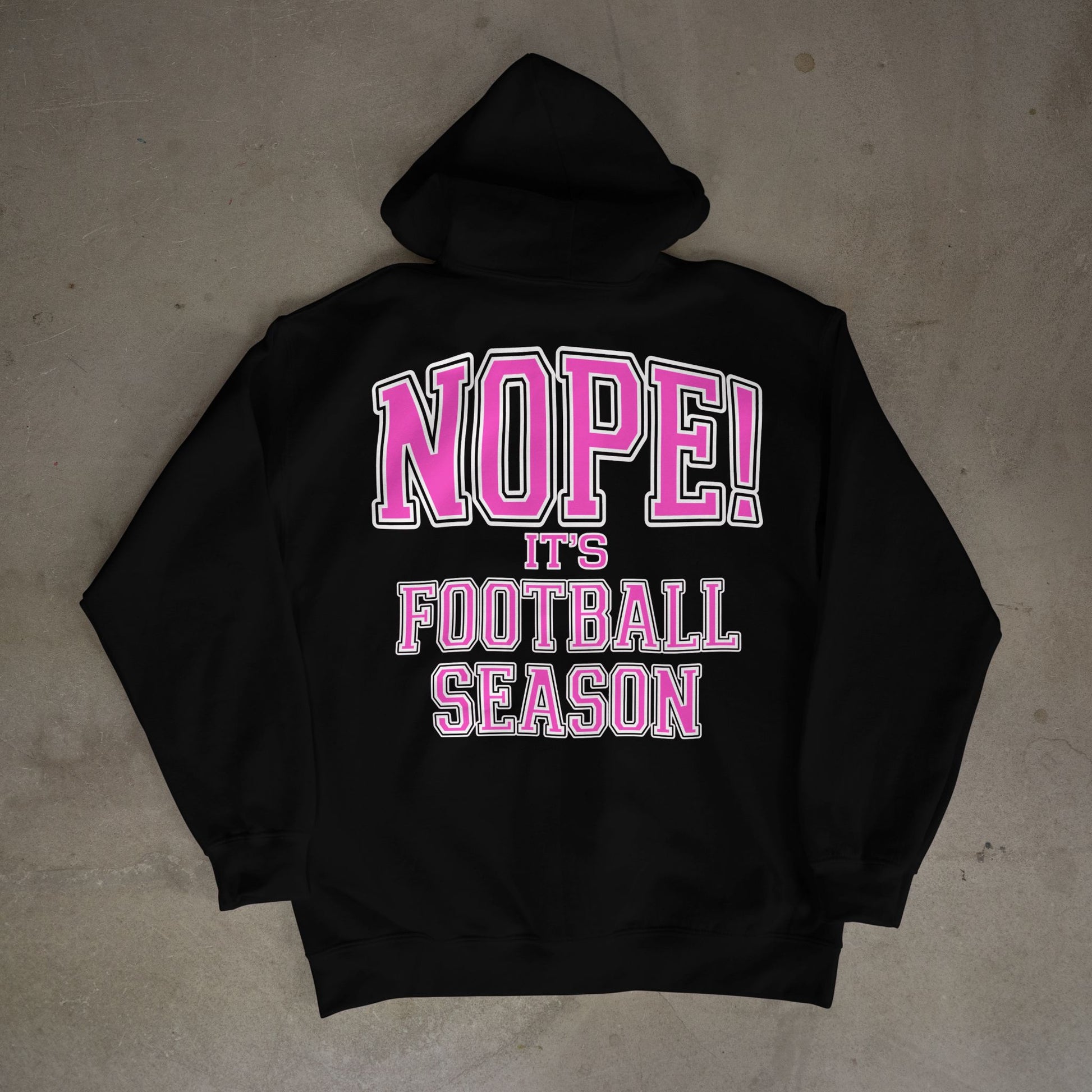 Black hoodie with pink and white text on a gray surface