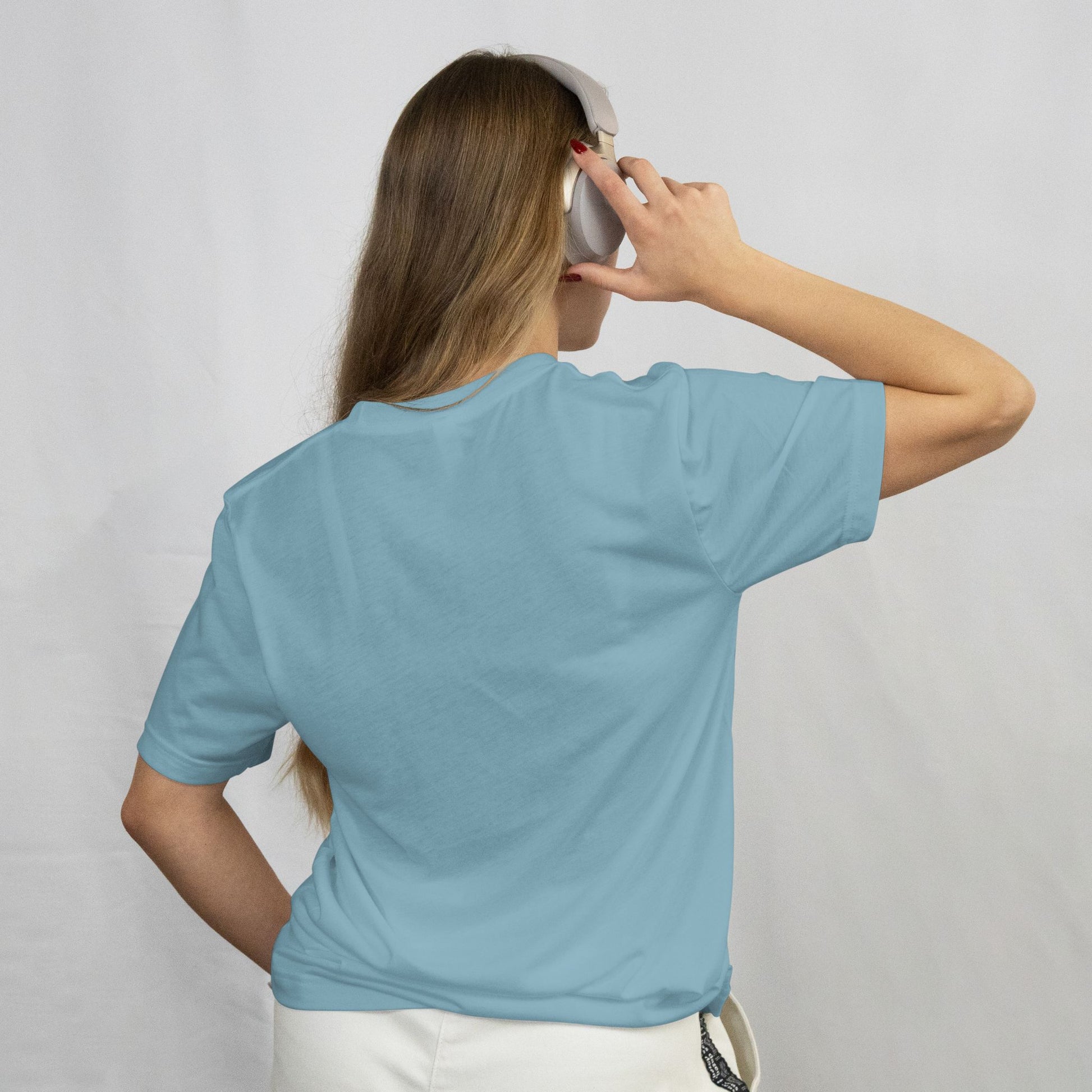 Person wearing a light blue t-shirt against a plain background
