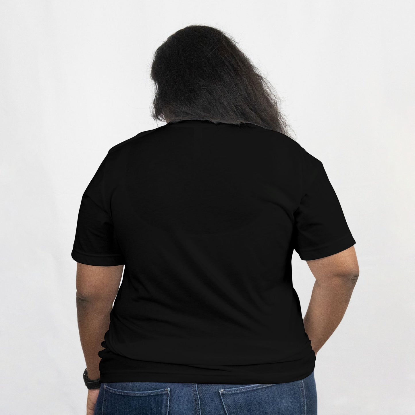 Person wearing a black t-shirt with a plain white background