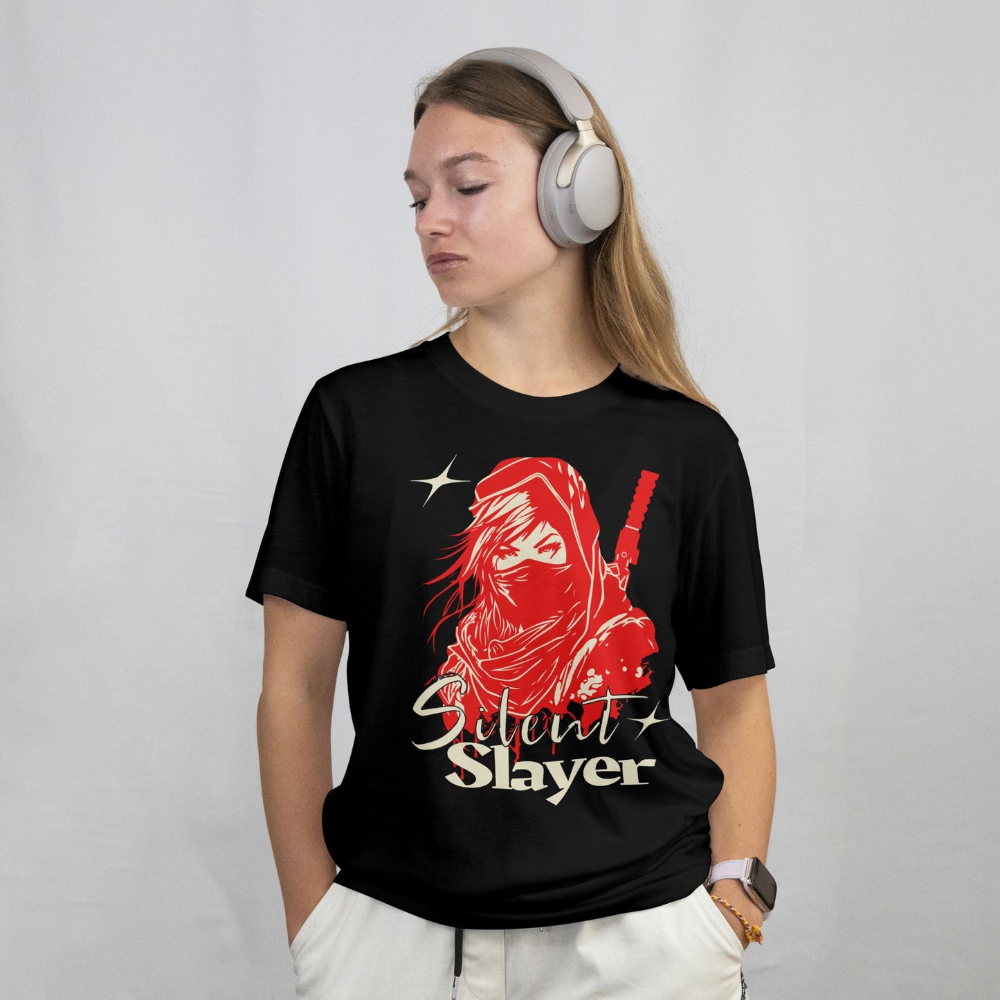 Person wearing a black t-shirt with a red graphic and 'Silent Slayer' text, headphones on, on a plain background