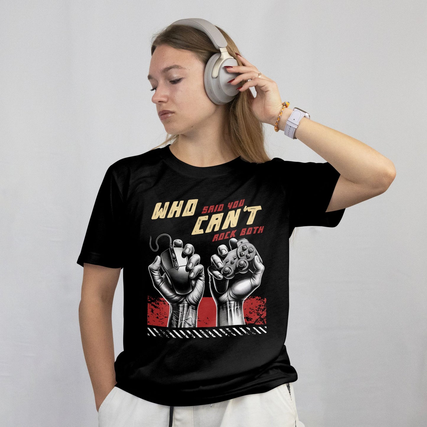 Person wearing a black t-shirt with graphic design and text, listening to music with headphones.